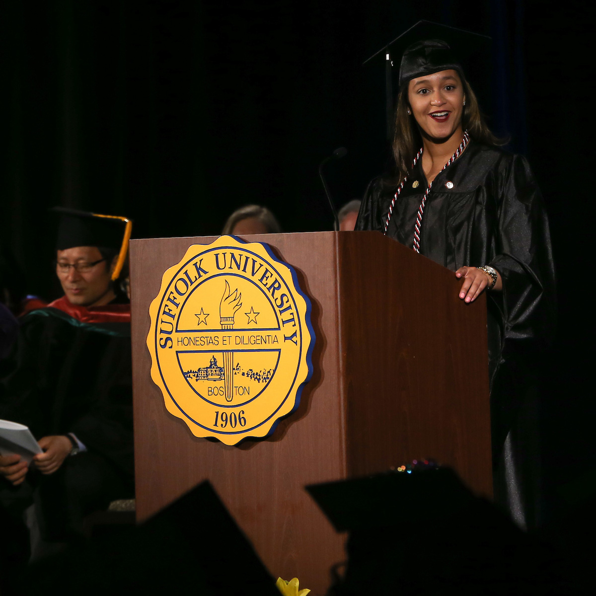 Elainy Mata giving a speech at her graduate degree Commencement ceremony.