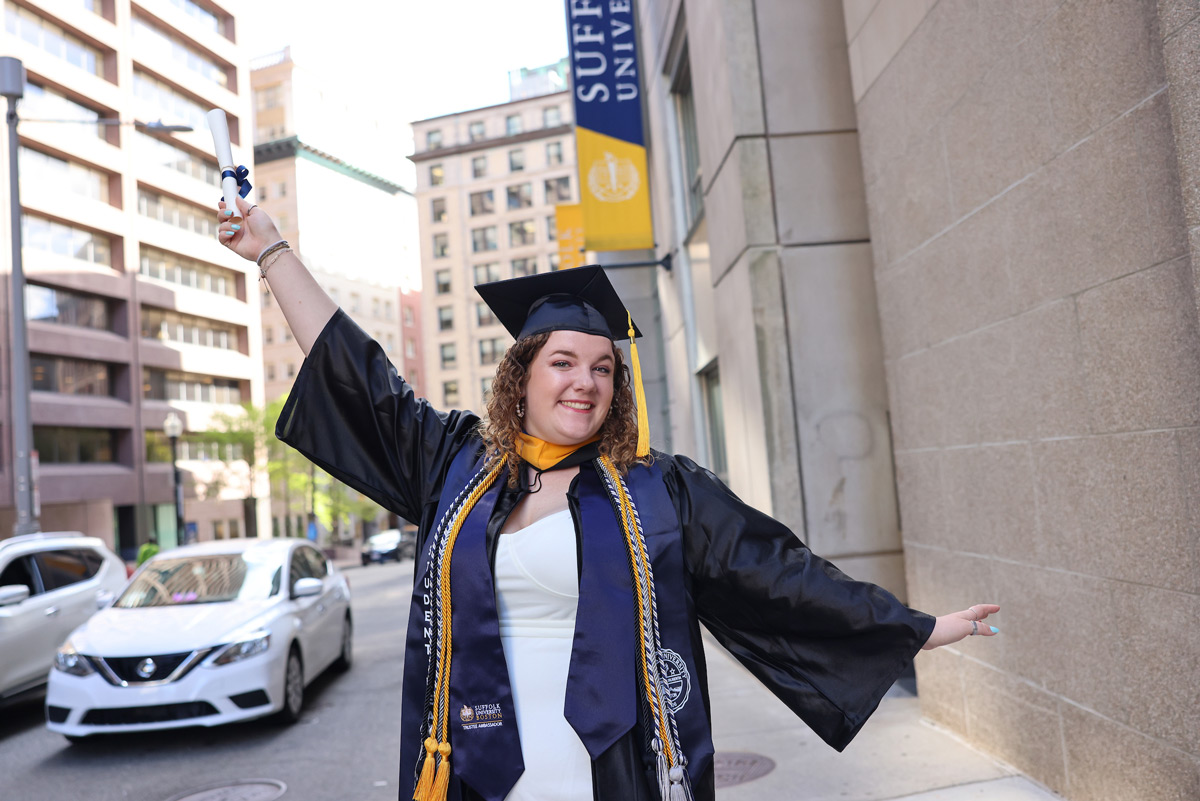 Portrait of Suffolk student Clara in her cap and gown.