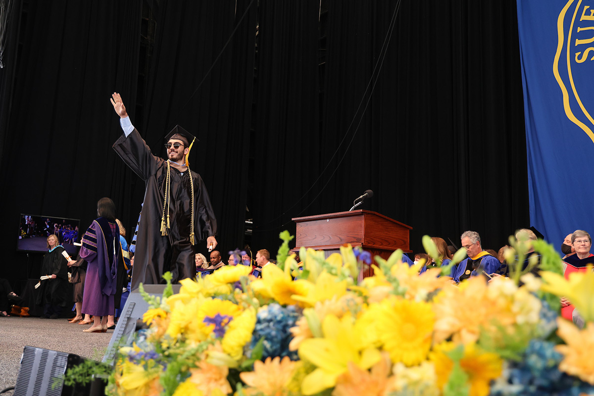 Suffolk student Domenico crosses the stage at Commencement.