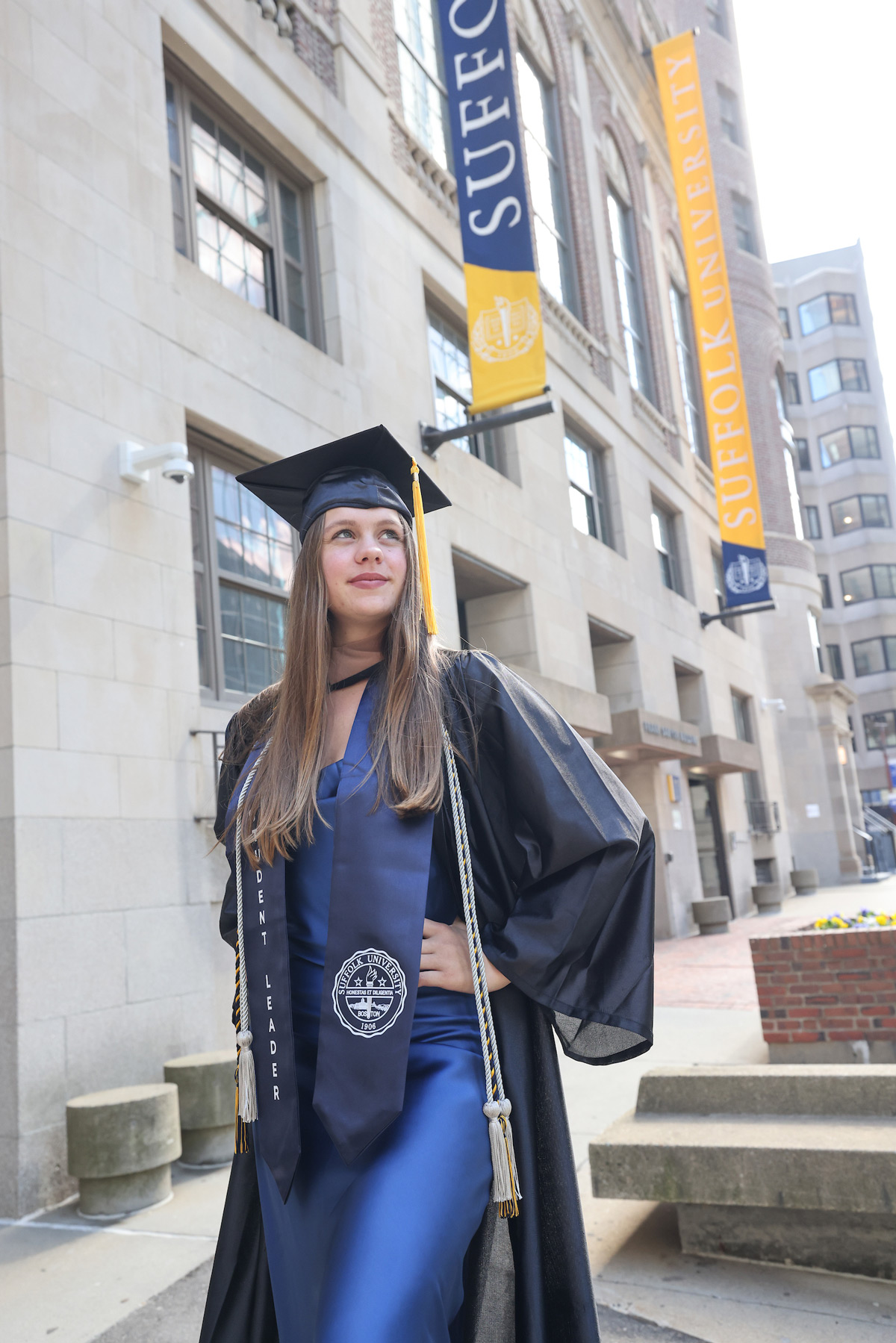 Portrait of Suffolk student Greta in her cap and gown.