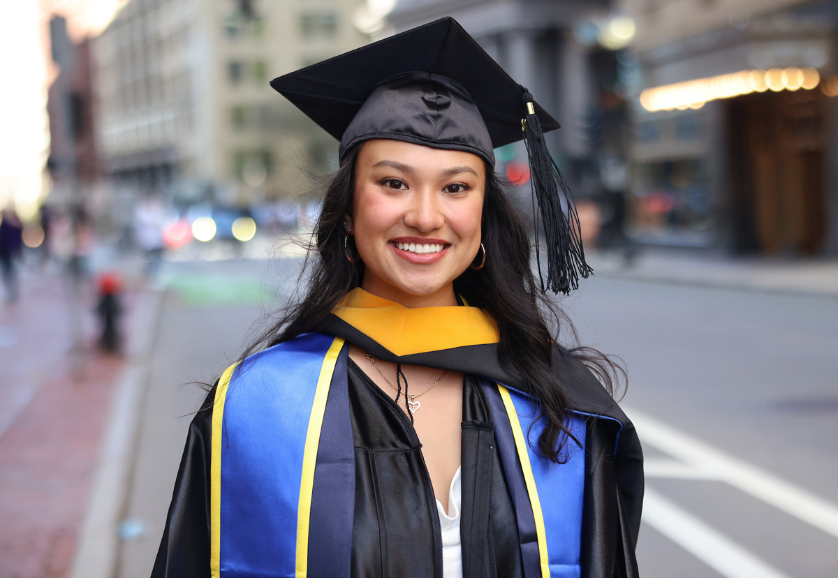 Portrait of Suffolk student Jessica in her cap and gown.