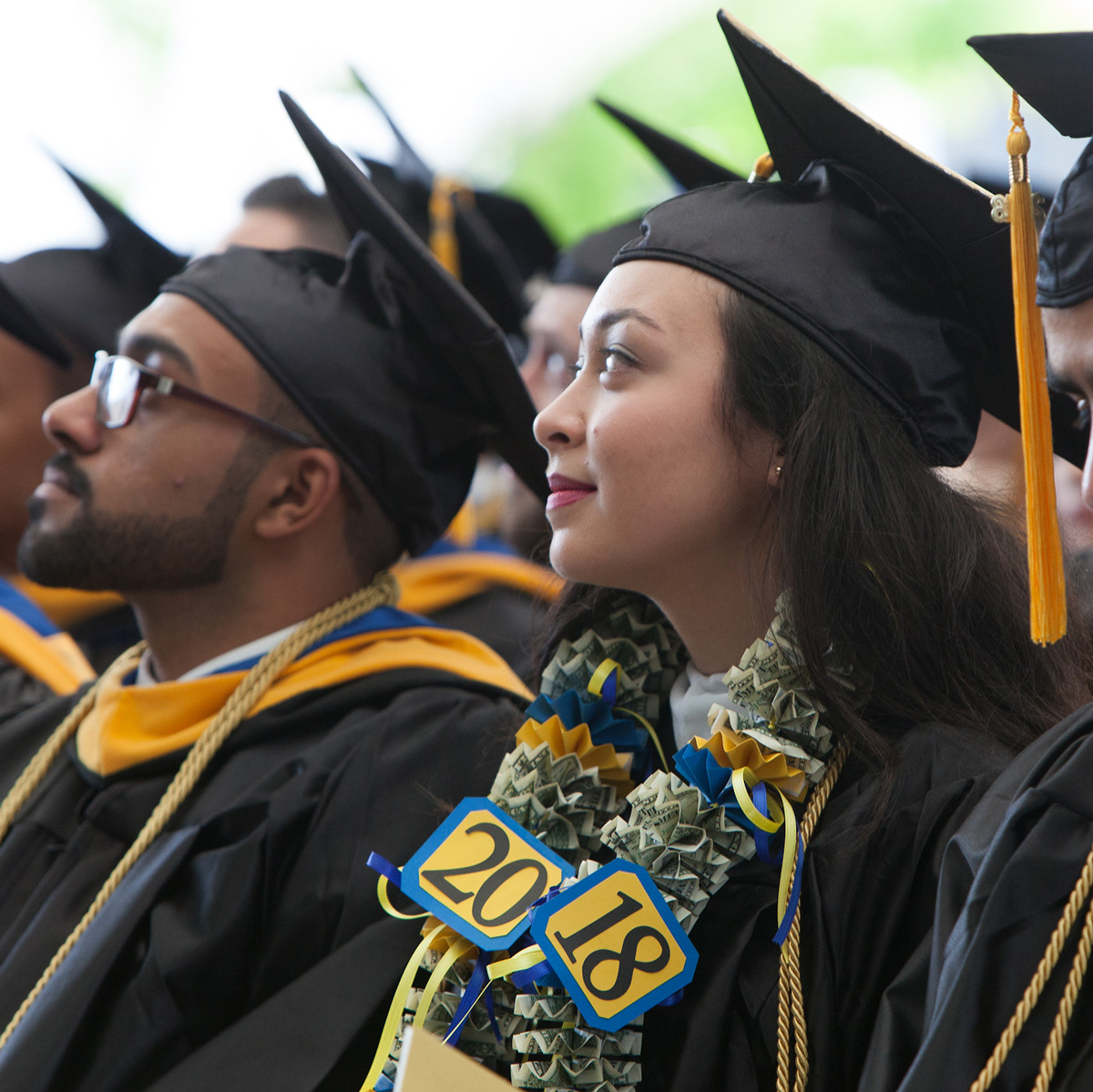 Shannon sitting in the crowd in her cap and gown during her Commencement ceremony.