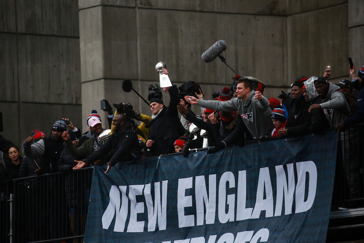 Quarterback Tom Brady and tight end Rob Gronkowski show off the Super Bowl trophy to the crowd following the Patriots Super Bowl victory parade.