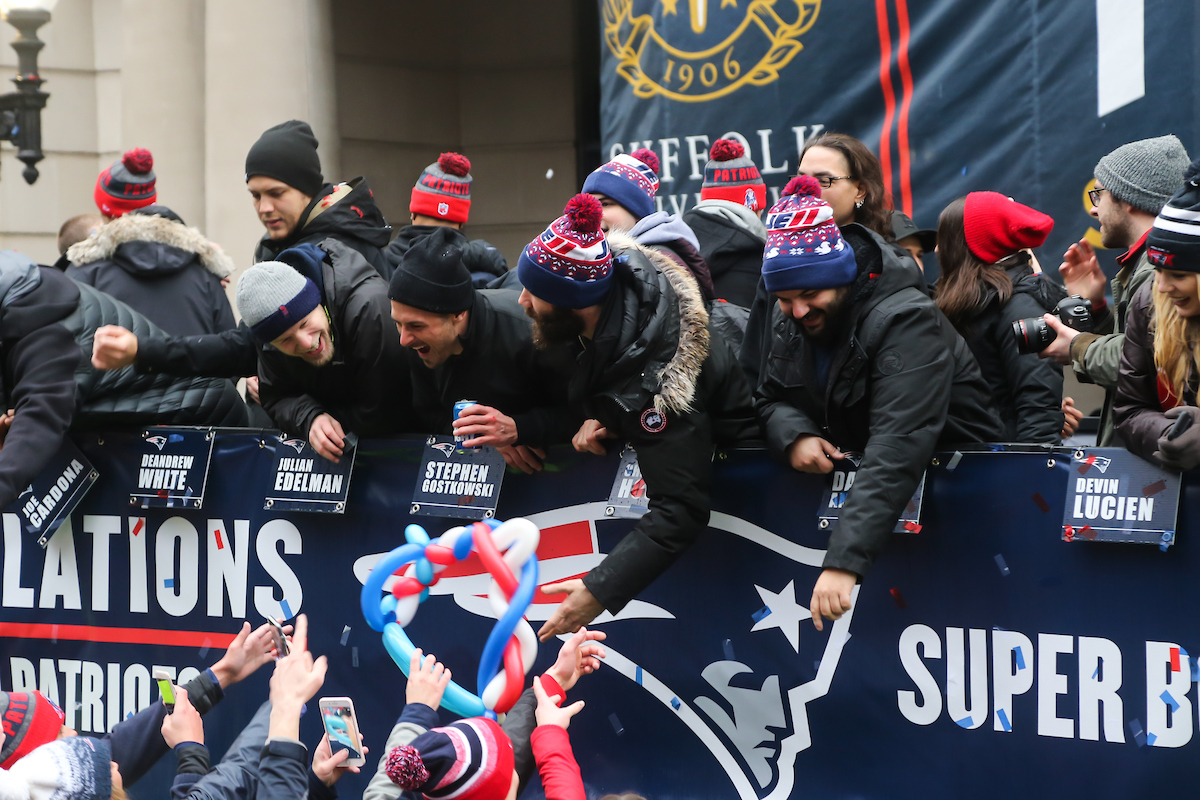 Wide receivers Danny Amendola and Julian Edelman reach out into the crowd of fans during the New England Patriots Super Bowl victory parade in front of Suffolk University's Sargent Hall.