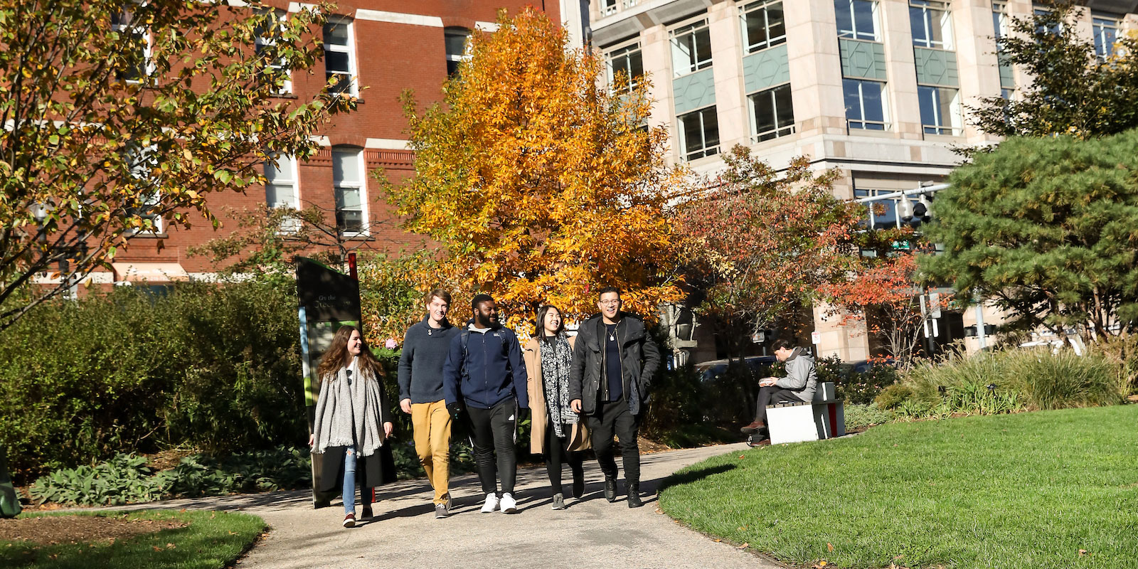 Suffolk students walk around in Boston's Rose Kennedy Greenway area.