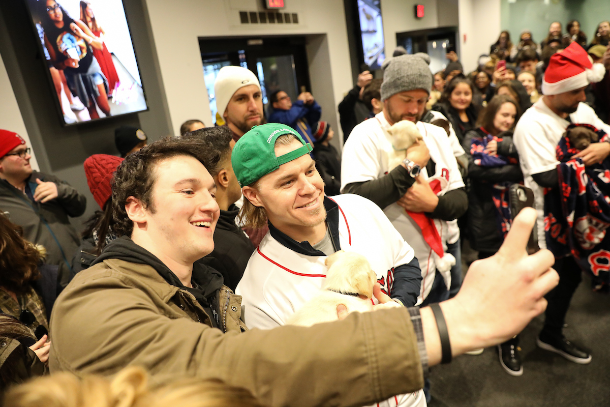 The Boston Red Sox visited Suffolk students with puppies the day before final exams begin.