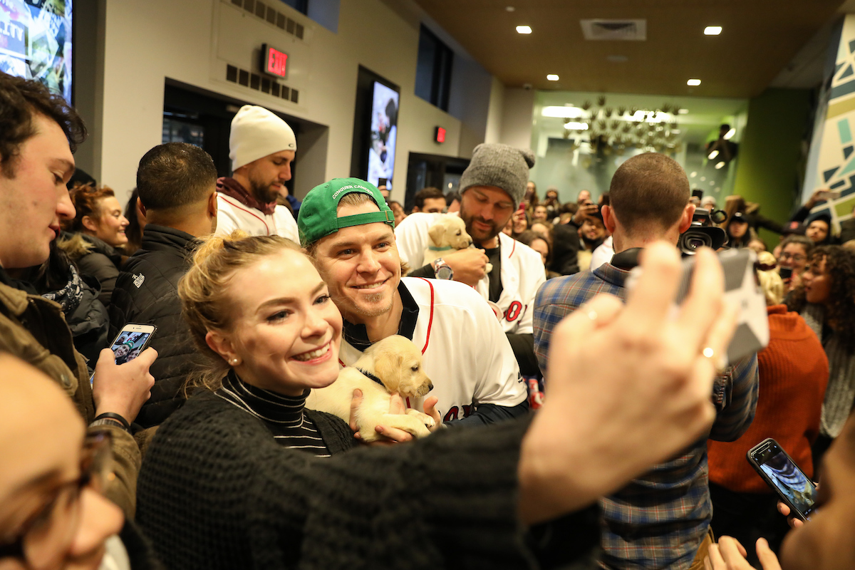 The Boston Red Sox visited Suffolk students with puppies the day before final exams begin.