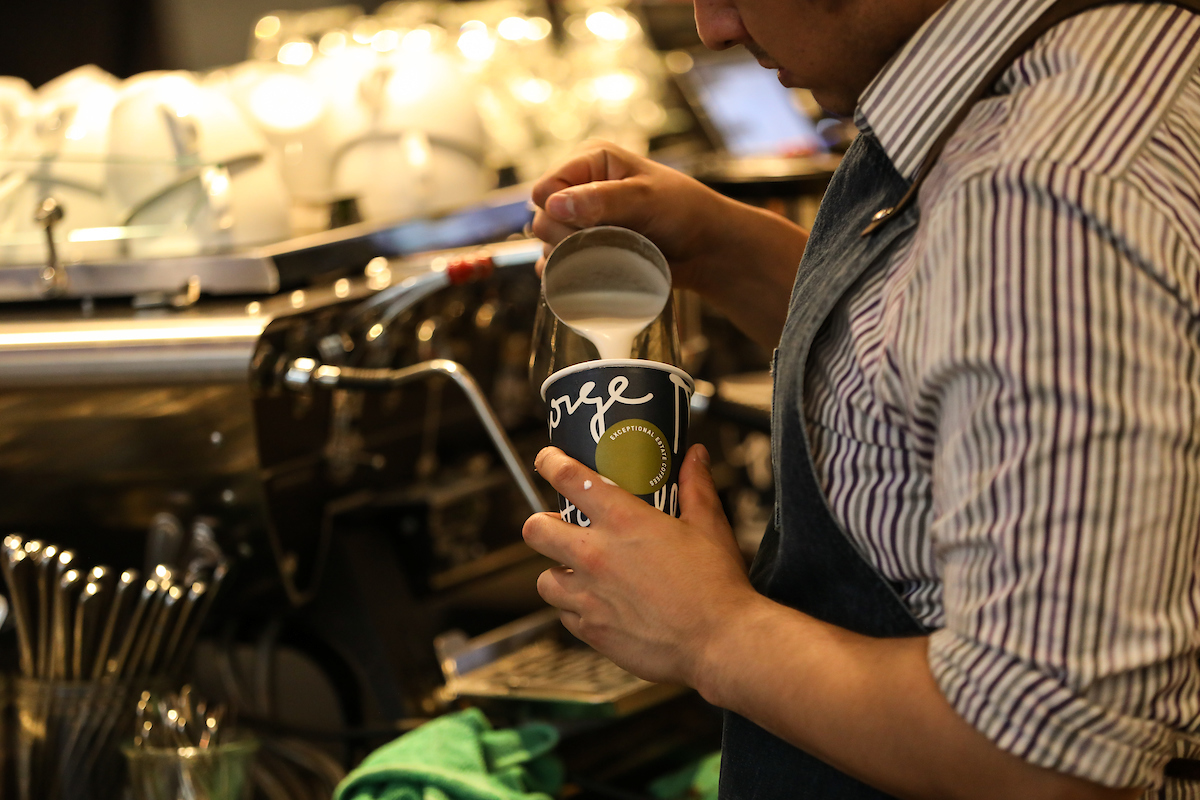 Suffolk students work with Boston-based artisanal coffee roaster George Howell during an experiential marketing class.