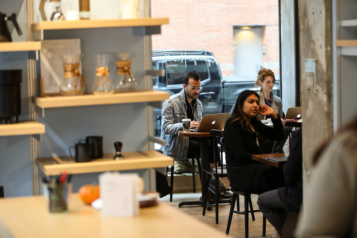 Suffolk students work with Boston-based artisanal coffee roaster George Howell during an experiential marketing class.