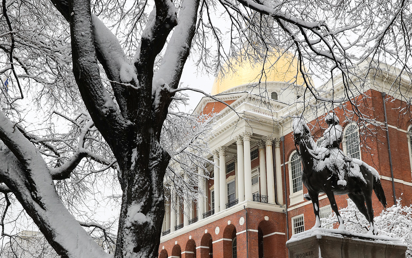 The golden dome of the State House gleams in the new snow