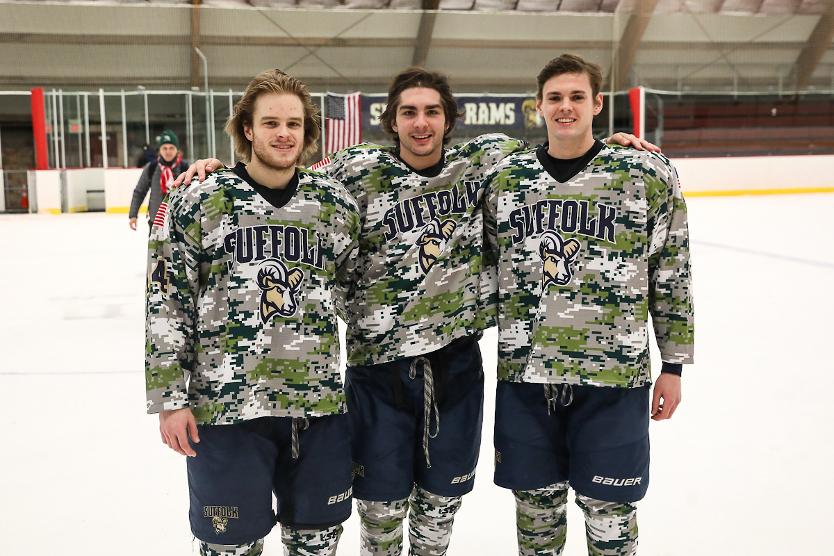 Suffolk players pose without helmets after hockey game is over. 