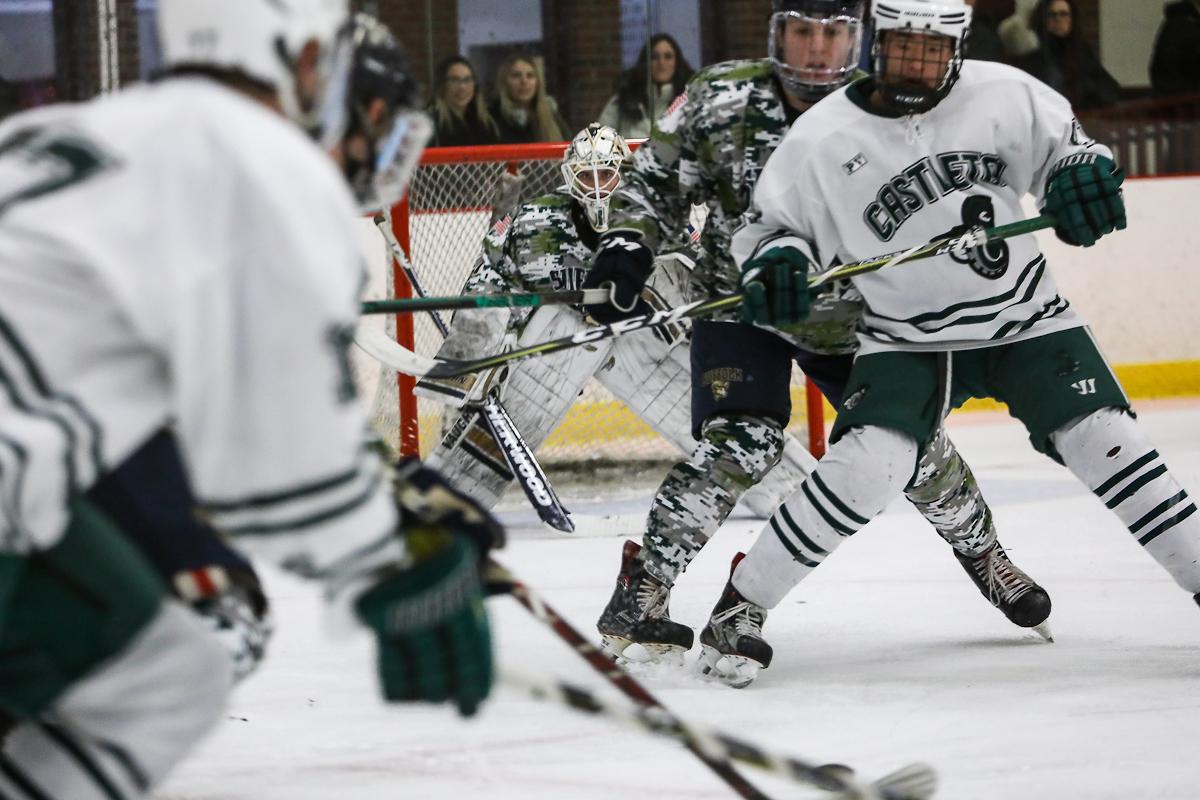 Suffolk goalie looks through the action to try and find the puck.
