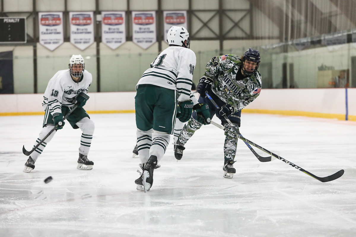 Suffolk player takes a shot from the point during hockey game. 