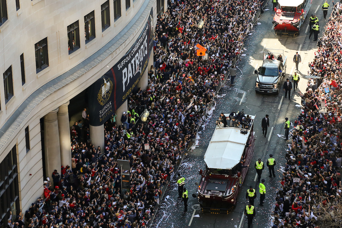Aerial shot of Duck Boats driving by Suffolk University.