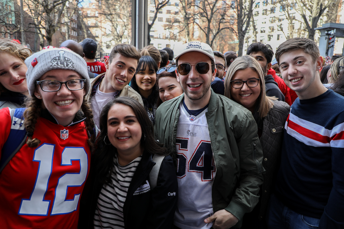Suffolk students getting ready for the Patriots parade, standing outside of 73 Tremont Street.