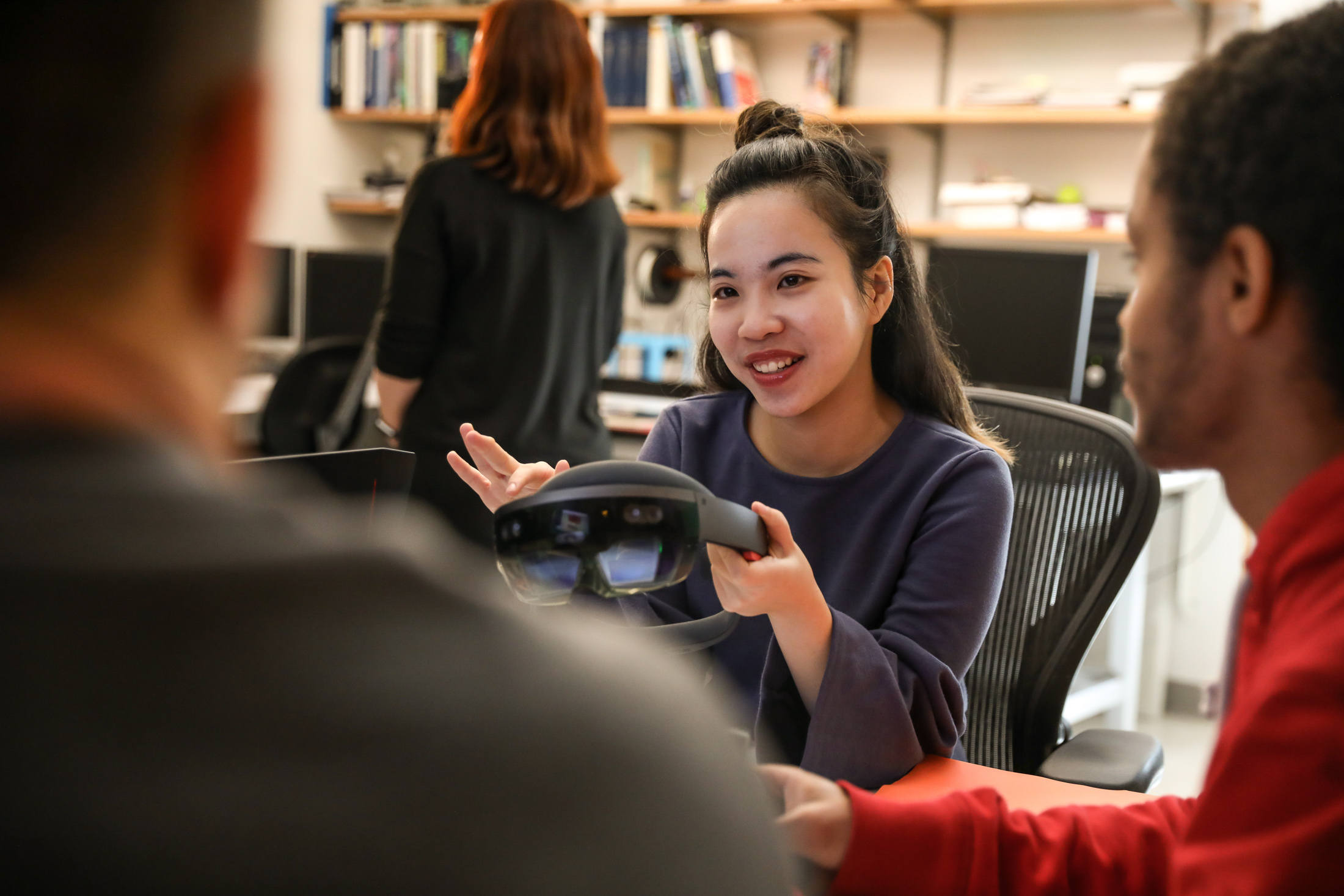 Students talking and holding a VR headset