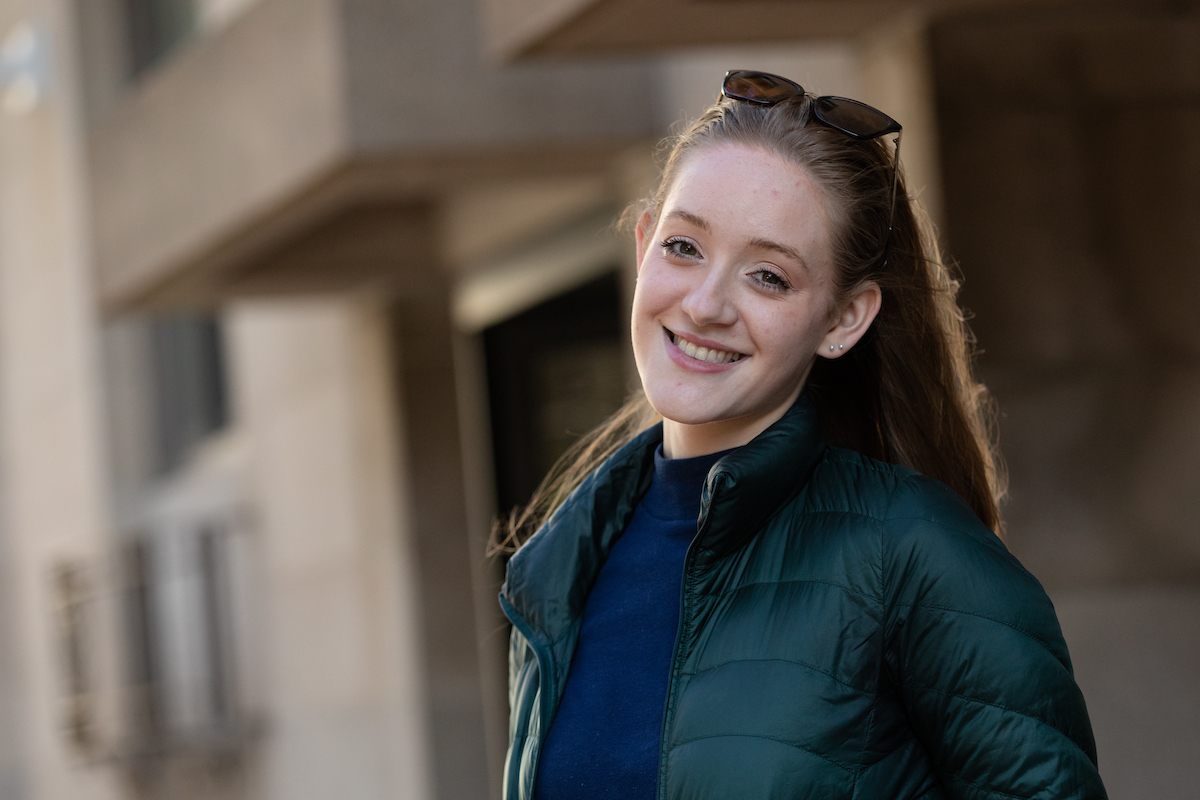 Suffolk student Christine poses for a portrait outside the Sawyer Building.