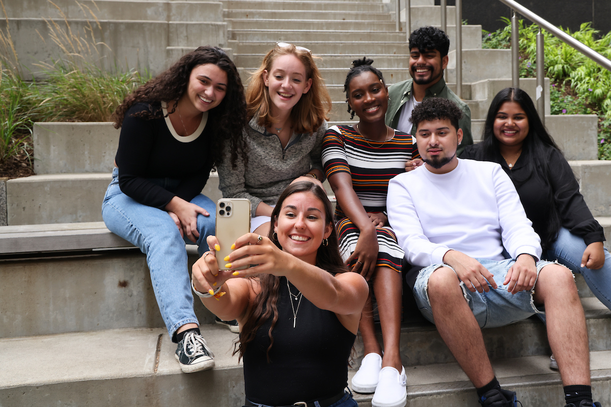 Suffolk student Christine poses for a picture with a group of friends on Roemer Plaza.