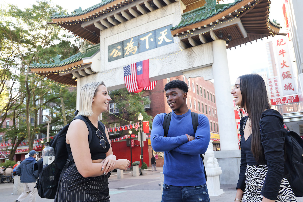 Suffolk students have a conversation during a walk through Chinatown in Boston.