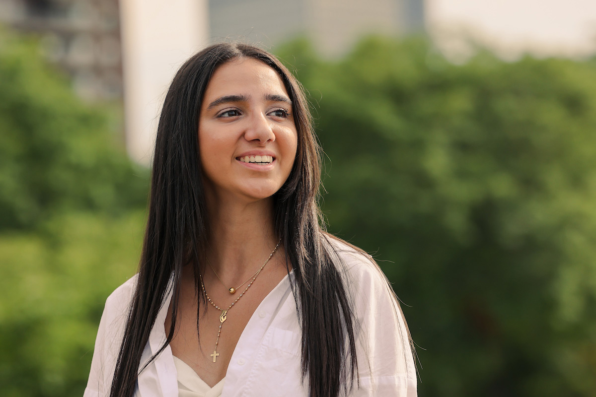 Suffolk student Angela poses for a photo on the Esplanade. 