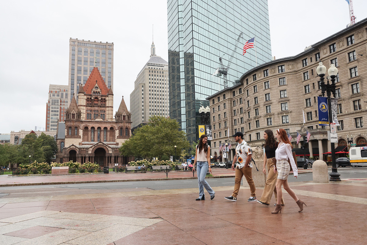 Suffolk students walk together past the Boston Public Library in Copley Square.