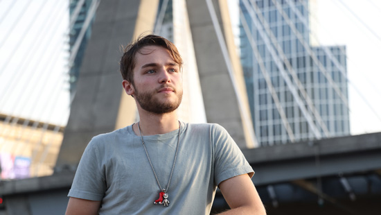 Suffolk student Hunter poses for a portrait by the Zakim Bridge in Boston.