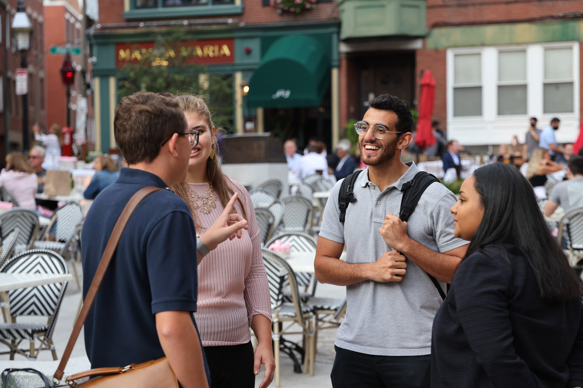 Suffolk student Mohammed talks with friends in Boston's North End.