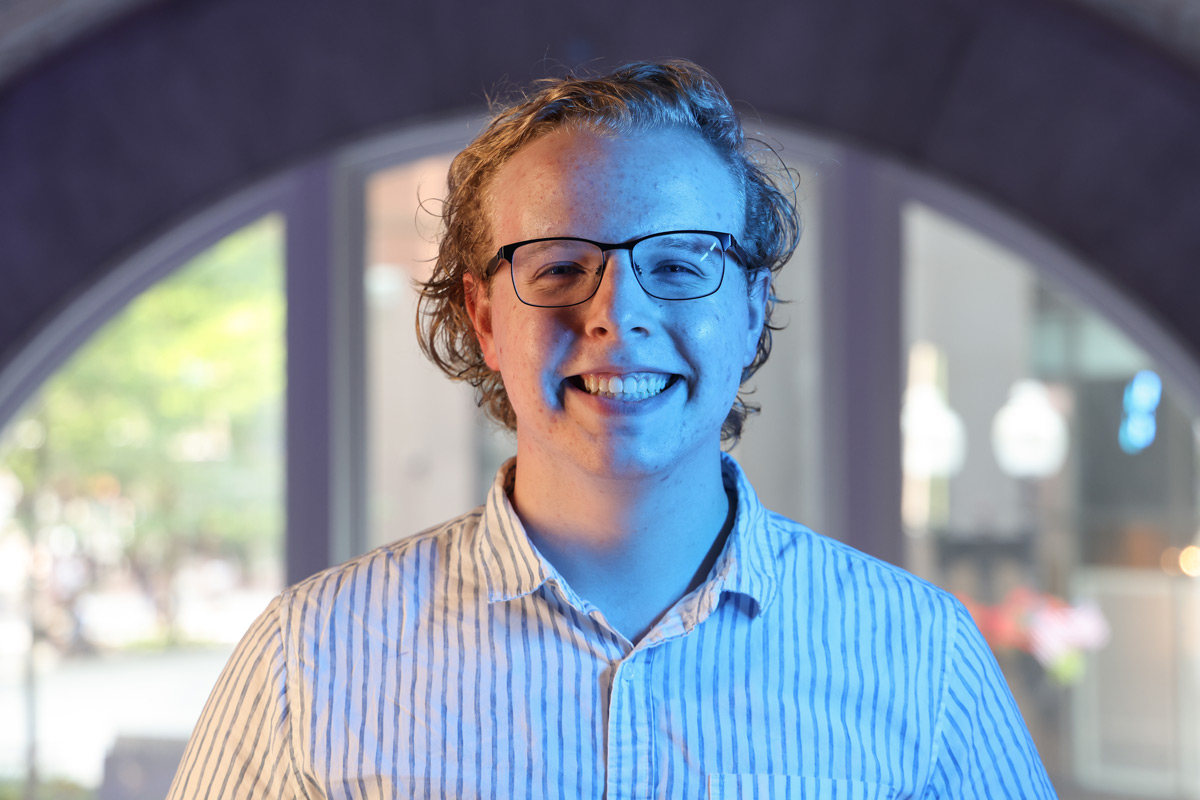 Suffolk student Collin poses for a portrait in the One Court Street residence hall in Boston.