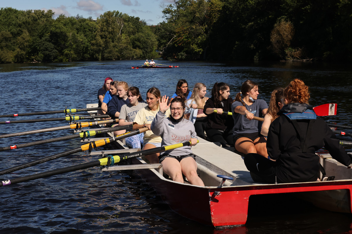 Suffolk student Morgan rows a boat on the Charles River with incoming Rams.