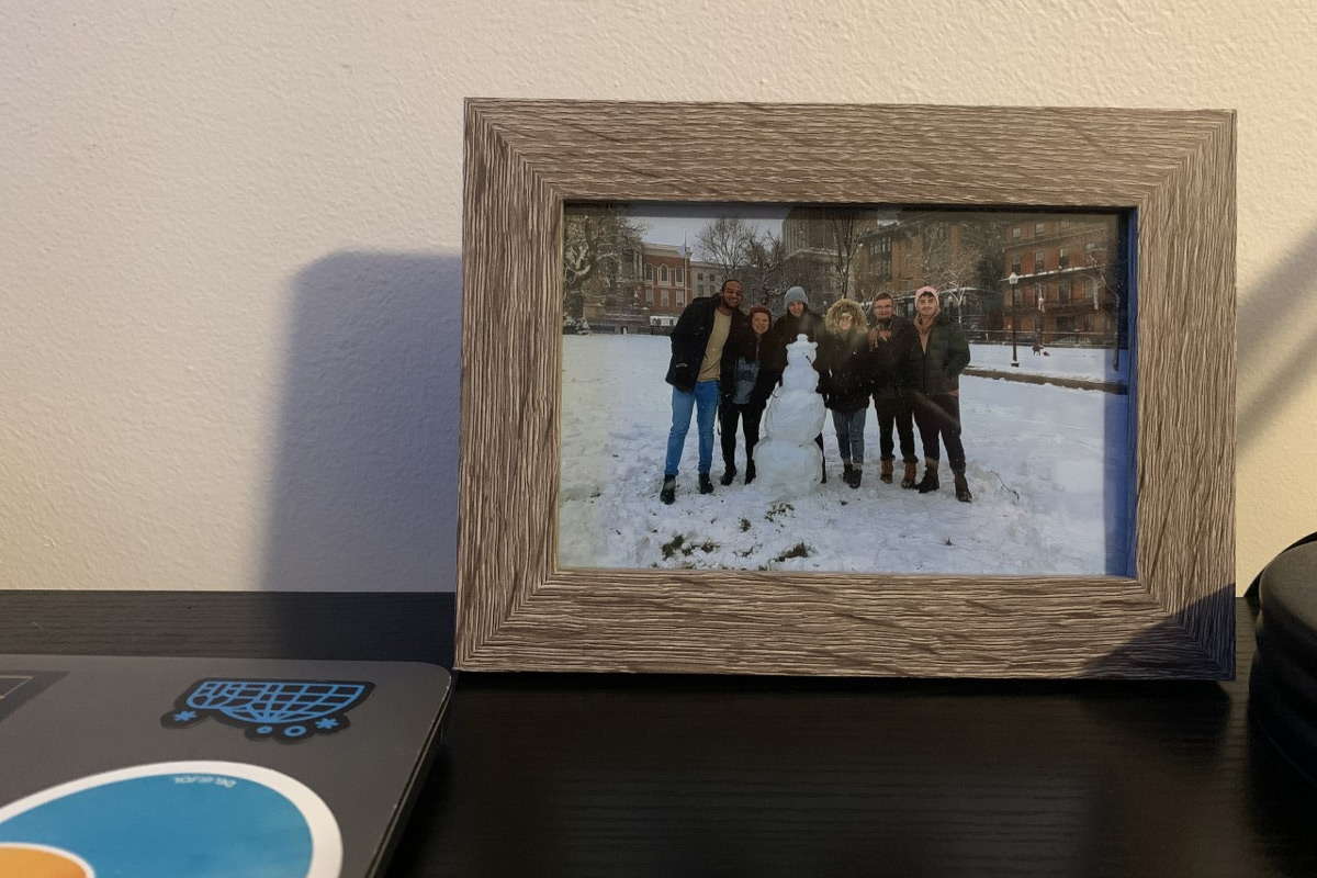 A framed photo on Suffolk student Omar's desk showcasing his first snowball fight on Boston Common.