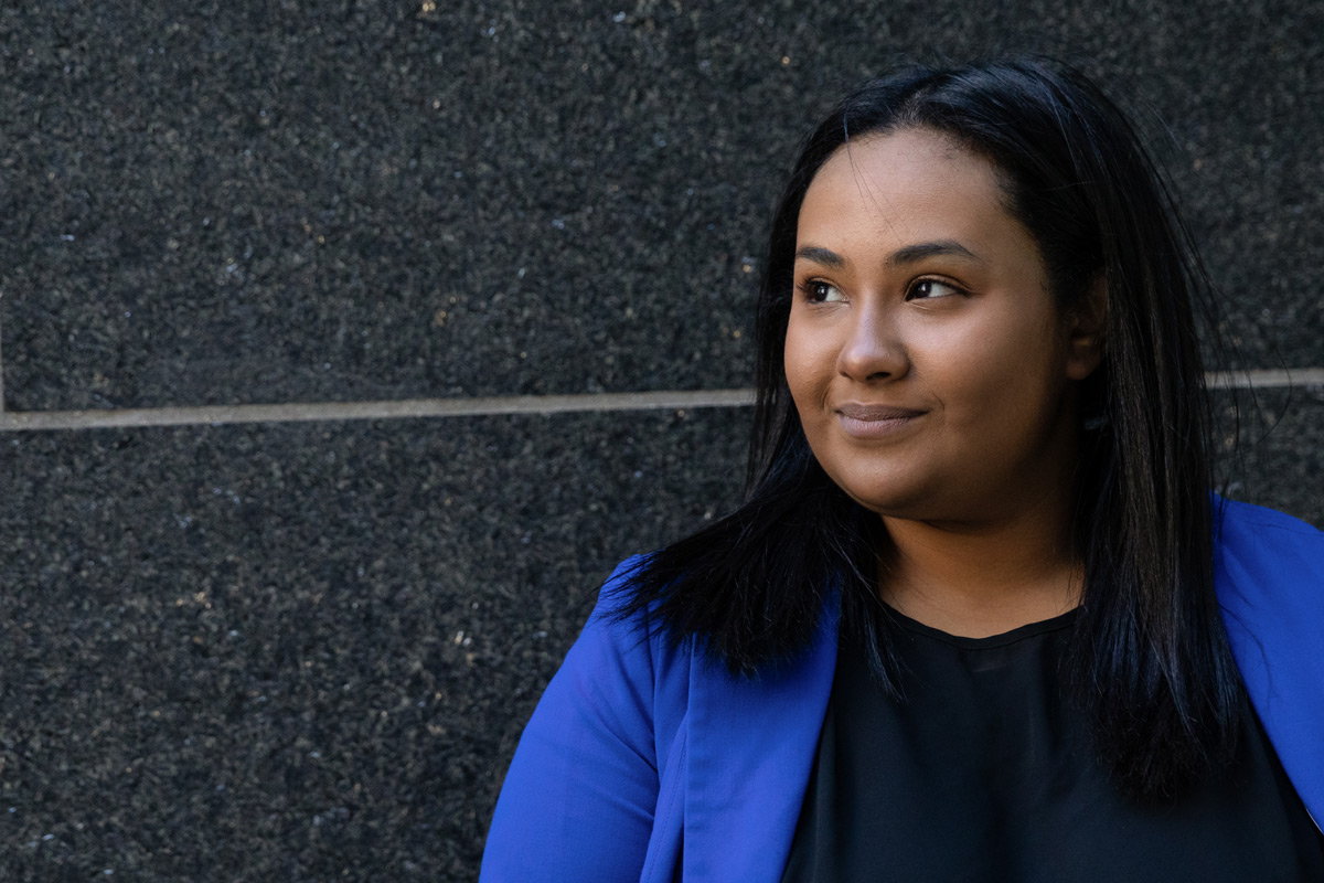 Suffolk alumnae Khadija poses for a portrait outside the Samia Academic Center.