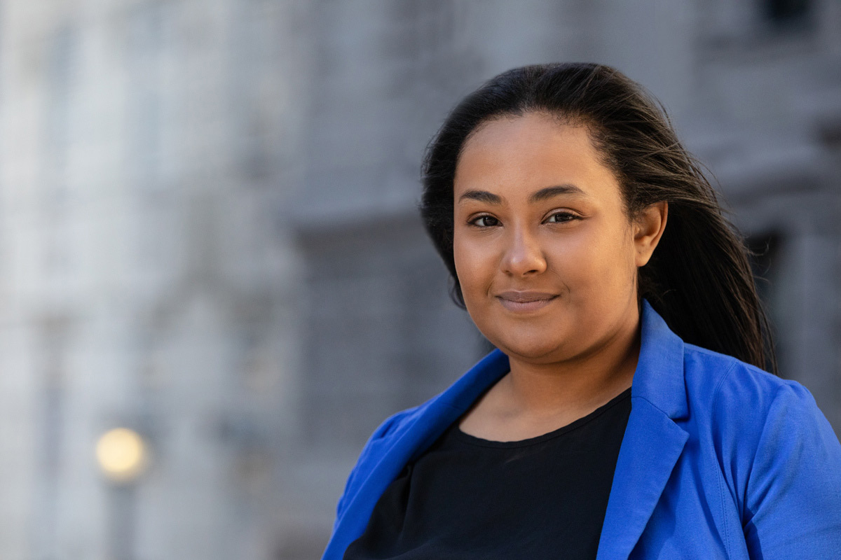 Suffolk alumnae Khadija poses for a portrait on Roemer Plaza in Boston.