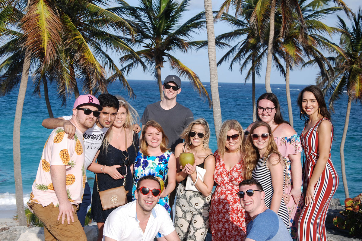 Suffolk Journey students pose by the beach during a visit to the island nation of Barbados.
