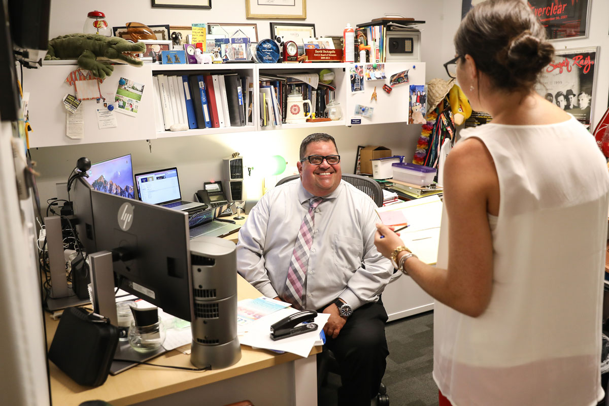 Suffolk SLI Director Dave DeAngelis sitting at his desk in his office.