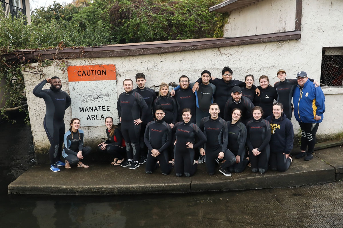 Suffolk Journey students posing on the dock before swimming with manatees.