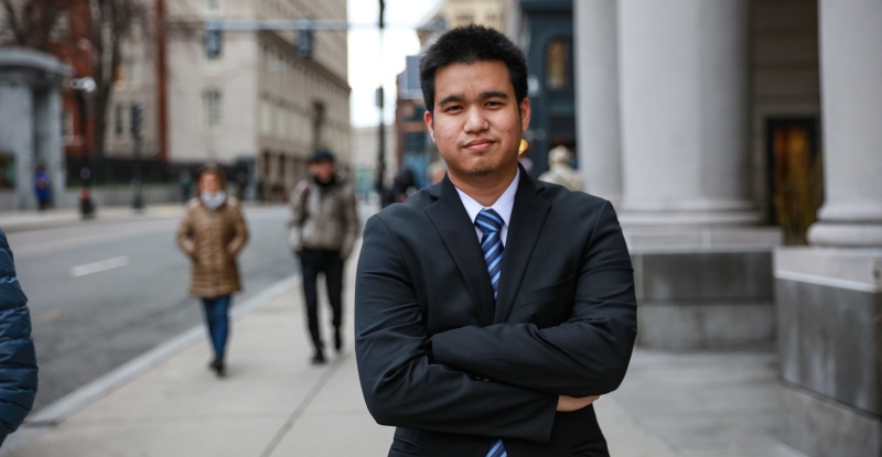 Suffolk Law student Anon Silpavuthi standing in front of the Sargent Hall