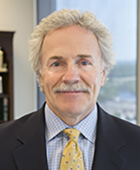 Headshot of Suffolk Law Alumnus Kevin Fitzgerald, white man with curly hair