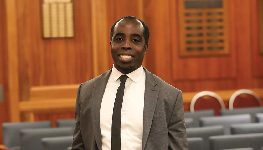 Suffolk alum standing in the courtroom.