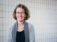 Susan Church stands in front of a wall