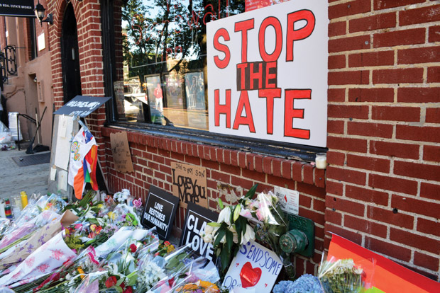 A wall with a sign saying "Stop the Hate"