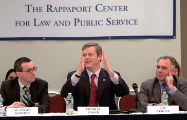 Charlie Baker motioning with his hands at panel 