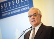 Barney Frank speaking at Sawyer Business School in a suit