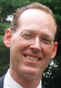 Paul Farmer outside with a suit