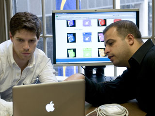 Two people working on a computer