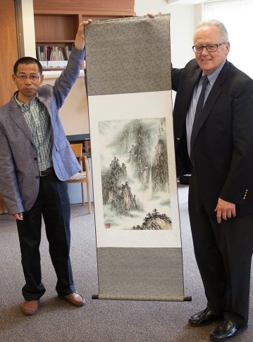 Linxiang Li presents scroll painting to Suffolk University President James McCarthy
