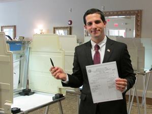 James V. DeAmicis holds a voting ballot