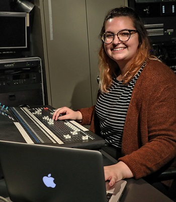 A student sitting at a mixing station