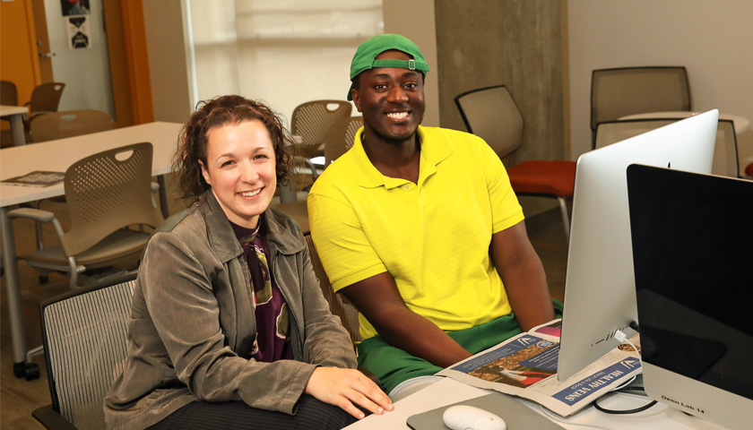 Professor Monika Raesch and student Clevis Murray at a computer station