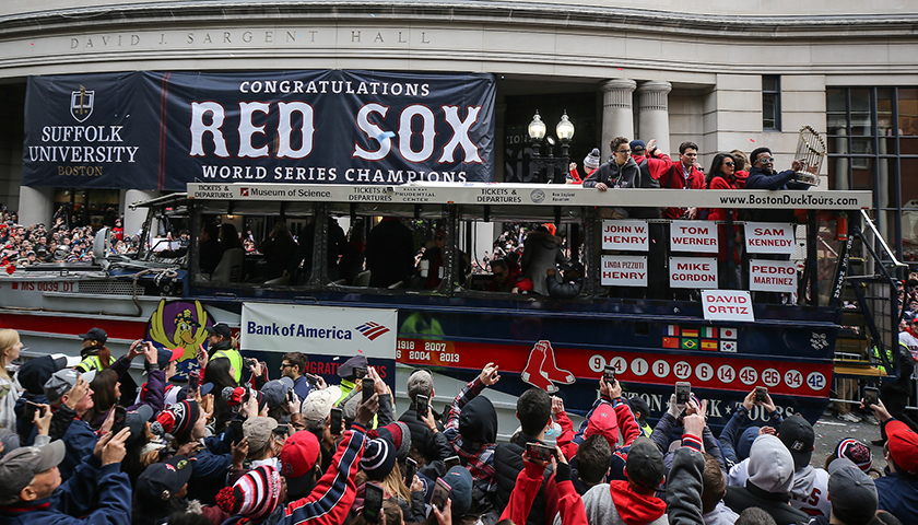 Duck boat with Red Sox veteran players passes by cheering fans outside Suffolk's Sargent Hall