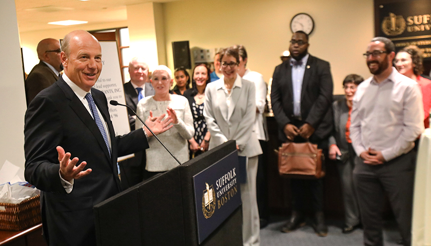 Gene Lee at podium with community members in background